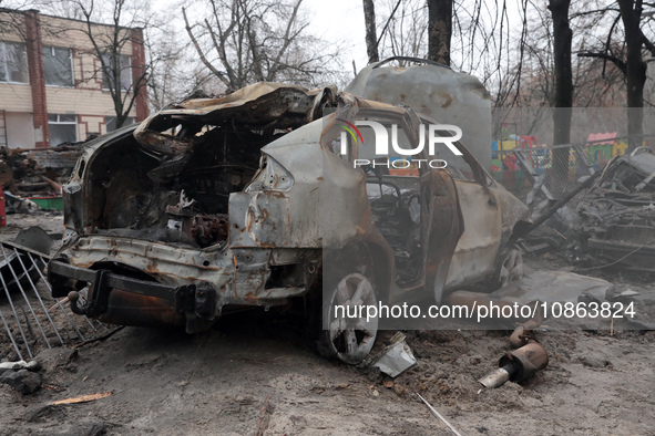 In Kyiv, Ukraine, on December 18, 2023, a burnt-out car is being seen in the yard of a residential building at 4A Ostafiia Dashkevycha Stree...