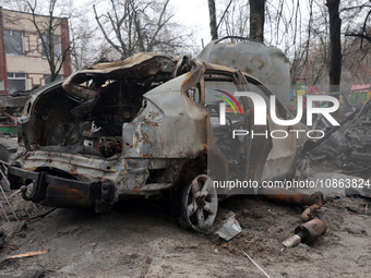 In Kyiv, Ukraine, on December 18, 2023, a burnt-out car is being seen in the yard of a residential building at 4A Ostafiia Dashkevycha Stree...