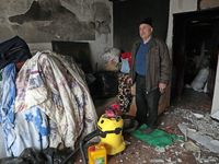 A man is standing inside the damaged apartment of Anatolii Luchok after the residential building at 4A Ostafiia Dashkevycha Street was struc...