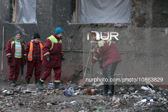 Municipal workers are removing the rubble outside the residential building at 4A Ostafiia Dashkevycha Street, which was damaged by the debri...