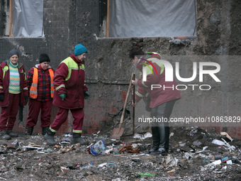 Municipal workers are removing the rubble outside the residential building at 4A Ostafiia Dashkevycha Street, which was damaged by the debri...