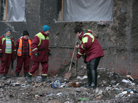 Municipal workers are removing the rubble outside the residential building at 4A Ostafiia Dashkevycha Street, which was damaged by the debri...