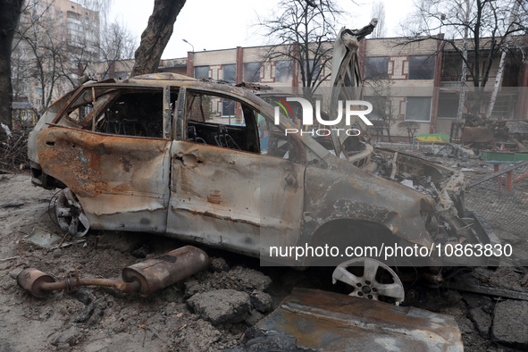 In Kyiv, Ukraine, on December 18, 2023, a burnt-out car is being seen in the yard of a residential building at 4A Ostafiia Dashkevycha Stree...