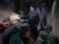 A man is standing inside the damaged apartment of Anatolii Luchok after the residential building at 4A Ostafiia Dashkevycha Street was struc...