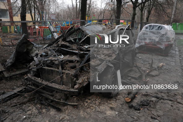 A burnt-out car is seen in the yard of a residential building at 4A Ostafiia Dashkevycha Street in Kyiv, Ukraine, on December 18, 2023, afte...