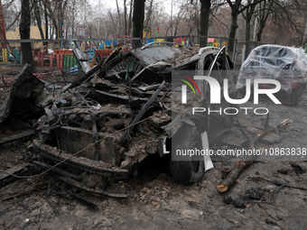 A burnt-out car is seen in the yard of a residential building at 4A Ostafiia Dashkevycha Street in Kyiv, Ukraine, on December 18, 2023, afte...