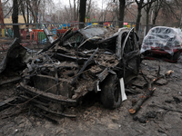 A burnt-out car is seen in the yard of a residential building at 4A Ostafiia Dashkevycha Street in Kyiv, Ukraine, on December 18, 2023, afte...