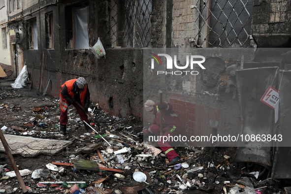 Municipal workers are removing the rubble outside the residential building at 4A Ostafiia Dashkevycha Street, which was damaged by the debri...