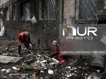 Municipal workers are removing the rubble outside the residential building at 4A Ostafiia Dashkevycha Street, which was damaged by the debri...