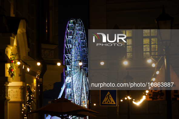 The Ferris wheel in Kontraktova Square is standing out at night in Kyiv, Ukraine, on December 18, 2023. 