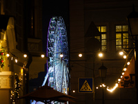 The Ferris wheel in Kontraktova Square is standing out at night in Kyiv, Ukraine, on December 18, 2023. (