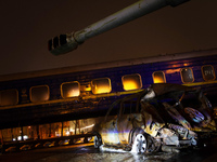 A wrecked car is being displayed in front of the Ukrzaliznytsia (Ukrainian Railways) train carriage, which was used for the evacuation of ci...