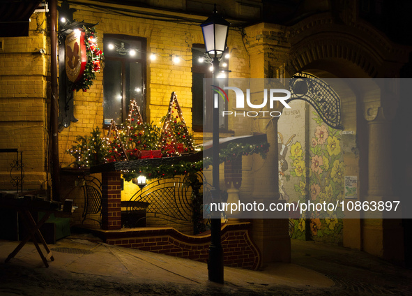 Christmas decorations are adorning an old building at night in Kyiv, Ukraine, on December 18, 2023. 