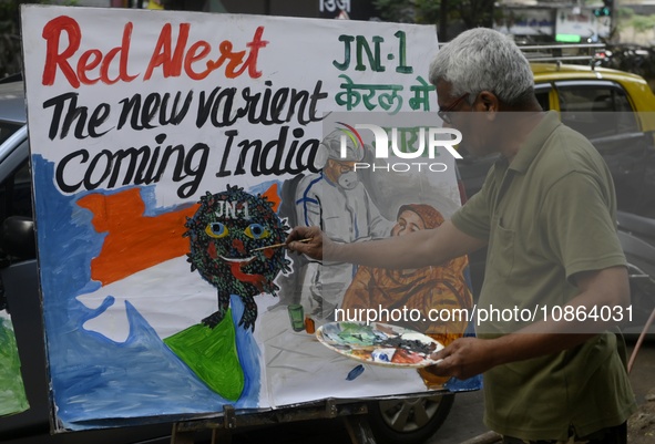 A teacher from a drawing academy is painting posters to raise awareness about the ongoing surge of the JN.1 Covid-19 variant, which is sprea...