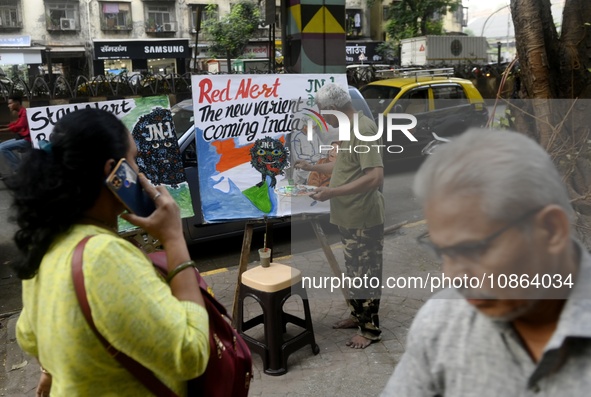 A teacher from a drawing academy is painting posters to raise awareness about the ongoing surge of the JN.1 Covid-19 variant, which is sprea...