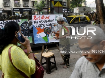 A teacher from a drawing academy is painting posters to raise awareness about the ongoing surge of the JN.1 Covid-19 variant, which is sprea...