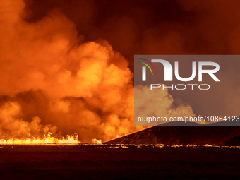 A volcano spews lava and smoke as it erupts in Grindavik, Iceland, December 18, 2023. (