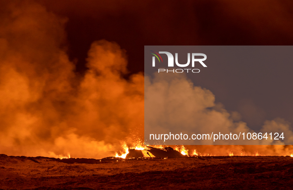 A volcano spews lava and smoke as it erupts in Grindavik, Iceland, December 18, 2023. 