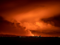 A view of the Bessastadir, the official residence of President of Iceland as volcano spews lava and smoke as it erupts in Grindavik, Iceland...