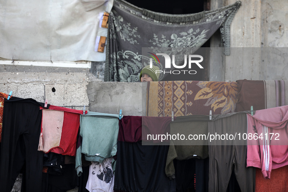 Palestinians are looking at the rubble of destroyed buildings following an Israeli bombing in Deir al-Balah, in the central Gaza Strip, on D...