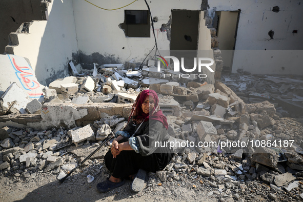 Palestinians are gathering amid the rubble of destroyed buildings following an Israeli bombardment in Deir El-Balah, in the central Gaza Str...