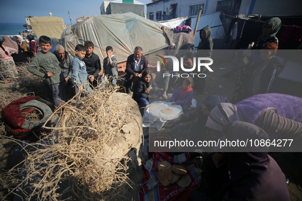 Displaced Palestinians are baking bread in Deir el-Balah, in the central Gaza Strip, on December 19, 2023, amid ongoing battles between Isra...