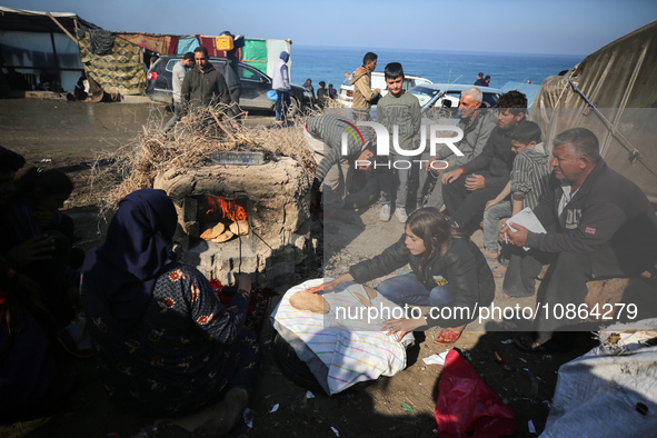 Displaced Palestinians are baking bread in Deir el-Balah, in the central Gaza Strip, on December 19, 2023, amid ongoing battles between Isra...