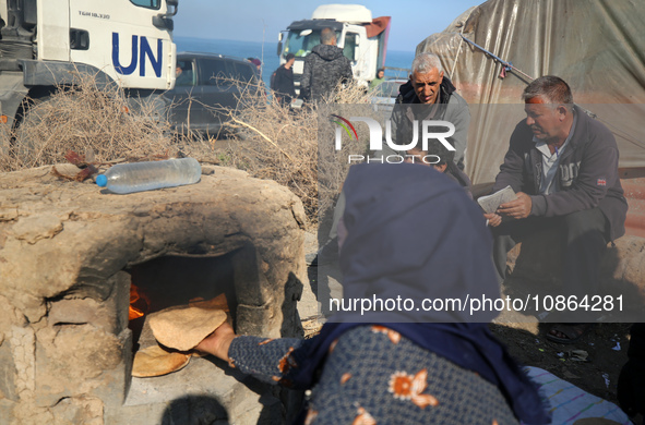 Displaced Palestinians are baking bread in Deir el-Balah, in the central Gaza Strip, on December 19, 2023, amid ongoing battles between Isra...