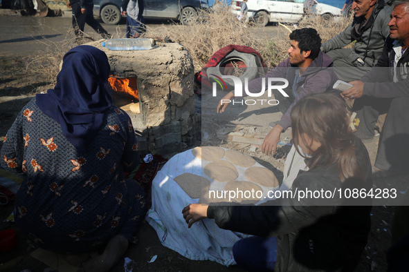 Displaced Palestinians are baking bread in Deir el-Balah, in the central Gaza Strip, on December 19, 2023, amid ongoing battles between Isra...