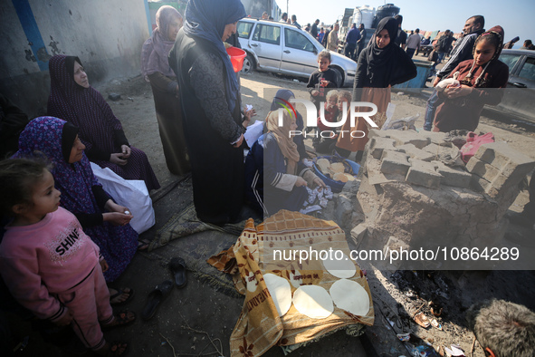 Displaced Palestinians are baking bread in Deir el-Balah, in the central Gaza Strip, on December 19, 2023, amid ongoing battles between Isra...