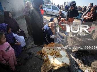 Displaced Palestinians are baking bread in Deir el-Balah, in the central Gaza Strip, on December 19, 2023, amid ongoing battles between Isra...