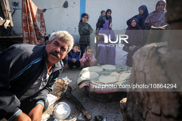 Displaced Palestinians are baking bread in Deir el-Balah, in the central Gaza Strip, on December 19, 2023, amid ongoing battles between Isra...