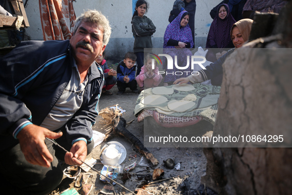 Displaced Palestinians are baking bread in Deir el-Balah, in the central Gaza Strip, on December 19, 2023, amid ongoing battles between Isra...