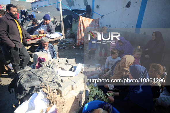 Displaced Palestinians are baking bread in Deir el-Balah, in the central Gaza Strip, on December 19, 2023, amid ongoing battles between Isra...