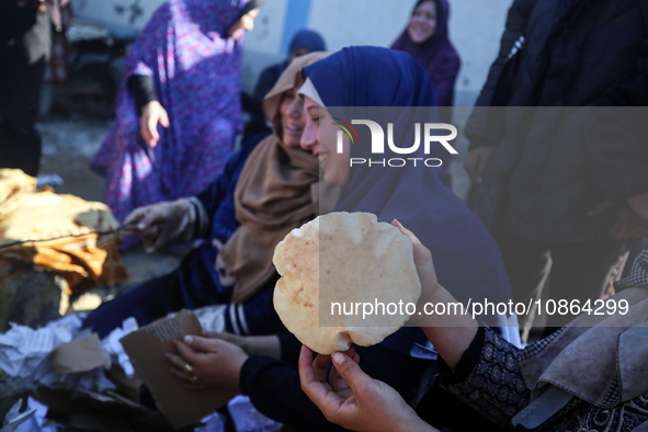 Displaced Palestinians are baking bread in Deir el-Balah, in the central Gaza Strip, on December 19, 2023, amid ongoing battles between Isra...