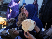 Displaced Palestinians are baking bread in Deir el-Balah, in the central Gaza Strip, on December 19, 2023, amid ongoing battles between Isra...