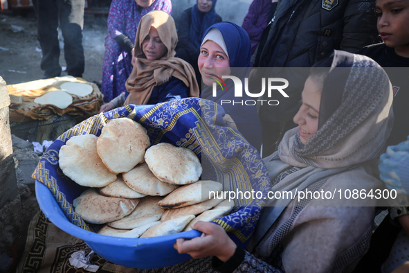 Displaced Palestinians are baking bread in Deir el-Balah, in the central Gaza Strip, on December 19, 2023, amid ongoing battles between Isra...