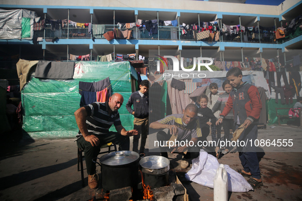 Displaced Palestinians are taking shelter in a UNRWA-affiliated Deir al-Balah school after fleeing their homes due to Israeli strikes, amid...