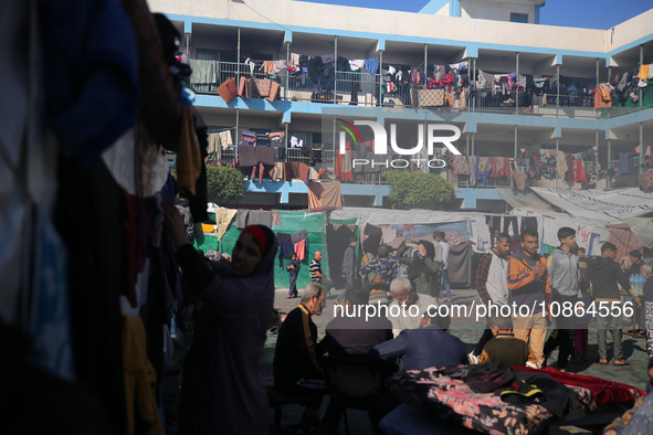 Displaced Palestinians are taking shelter in a UNRWA-affiliated Deir al-Balah school after fleeing their homes due to Israeli strikes, amid...