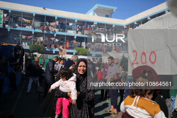 Displaced Palestinians are taking shelter in a UNRWA-affiliated Deir al-Balah school after fleeing their homes due to Israeli strikes, amid...