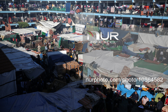 Displaced Palestinians are taking shelter in a UNRWA-affiliated Deir al-Balah school after fleeing their homes due to Israeli strikes, amid...