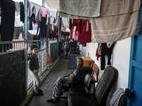 Displaced Palestinians are taking shelter in a UNRWA-affiliated Deir al-Balah school after fleeing their homes due to Israeli strikes, amid...