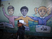 Displaced Palestinians are taking shelter in a UNRWA-affiliated Deir al-Balah school after fleeing their homes due to Israeli strikes, amid...