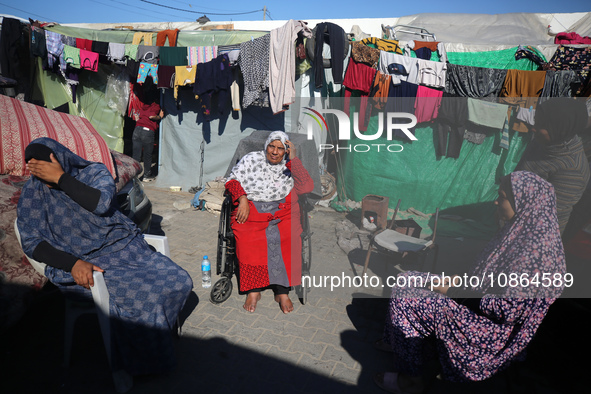 Displaced Palestinians are taking shelter in a UNRWA-affiliated Deir al-Balah school after fleeing their homes due to Israeli strikes, amid...