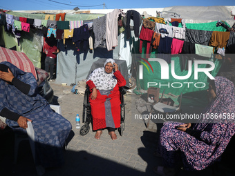 Displaced Palestinians are taking shelter in a UNRWA-affiliated Deir al-Balah school after fleeing their homes due to Israeli strikes, amid...