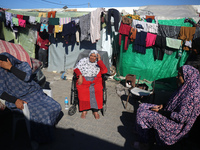 Displaced Palestinians are taking shelter in a UNRWA-affiliated Deir al-Balah school after fleeing their homes due to Israeli strikes, amid...