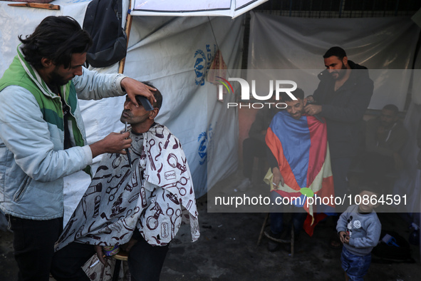 Displaced Palestinians are taking shelter in a UNRWA-affiliated Deir al-Balah school after fleeing their homes due to Israeli strikes, amid...