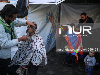 Displaced Palestinians are taking shelter in a UNRWA-affiliated Deir al-Balah school after fleeing their homes due to Israeli strikes, amid...