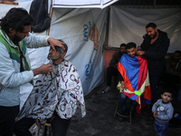 Displaced Palestinians are taking shelter in a UNRWA-affiliated Deir al-Balah school after fleeing their homes due to Israeli strikes, amid...