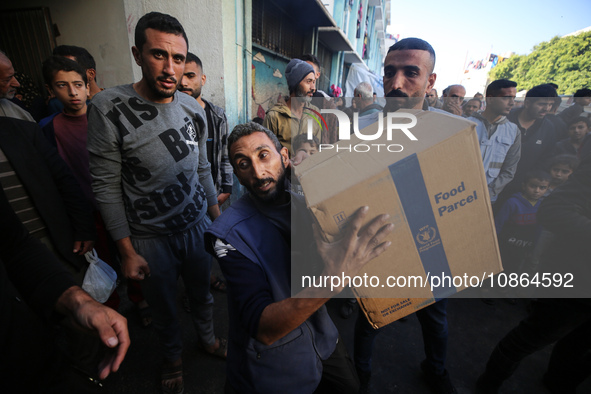 Displaced Palestinians are taking shelter in a UNRWA-affiliated Deir al-Balah school after fleeing their homes due to Israeli strikes, amid...